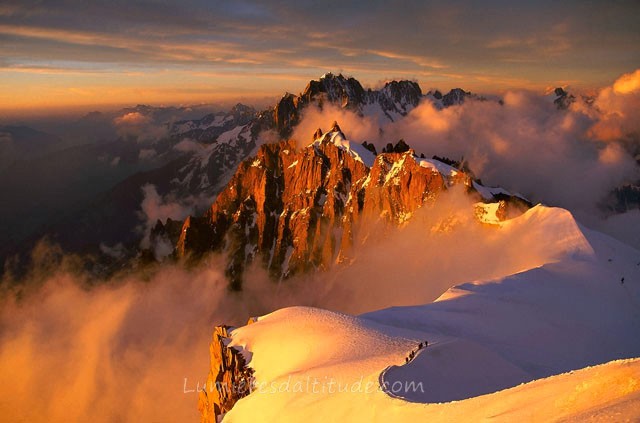 ALPINISTS AT SUNRISE ON THE ARETE MIDI-PLAN, MASSIF DU MONT-BLANC, HAUTE SAVOIE, FRANCE